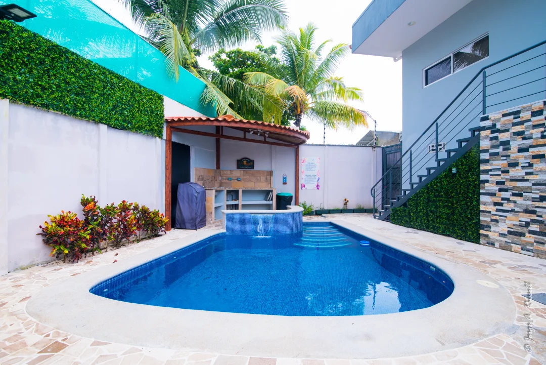 Pool and jacuzzi surrounded by tropical gardens