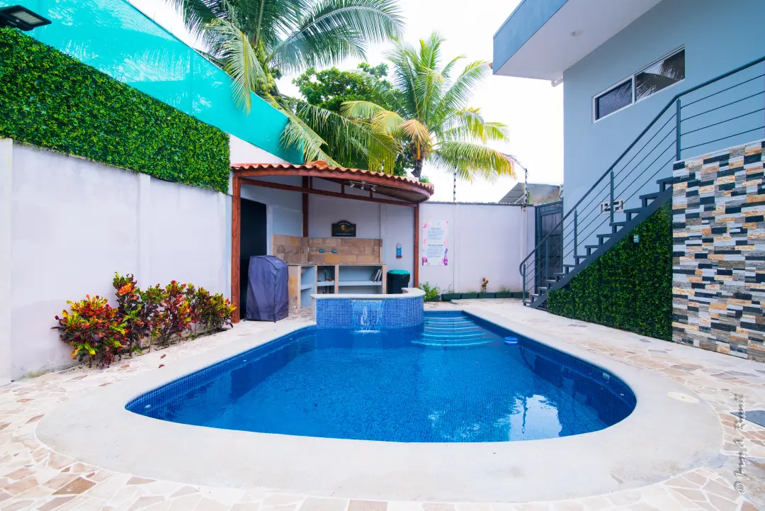 Pool and jacuzzi surrounded by tropical gardens