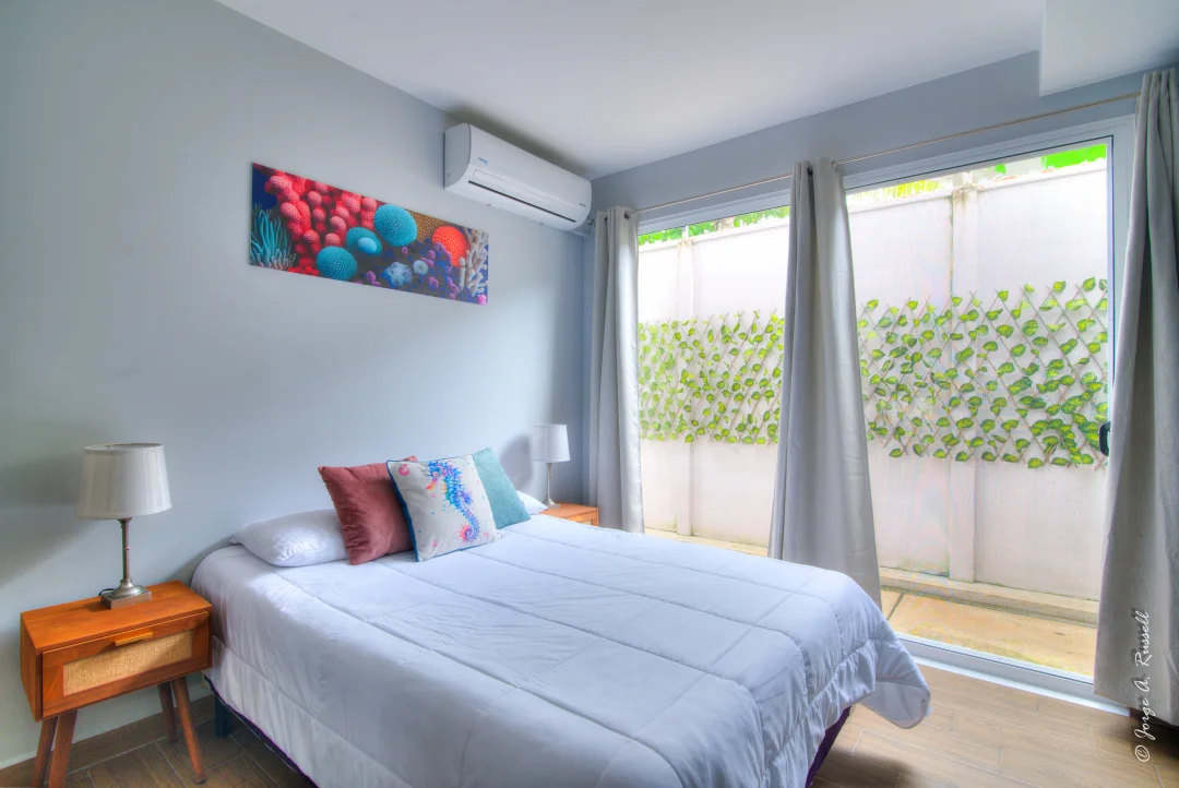 Corals Brisa · bedroom opening onto the patio