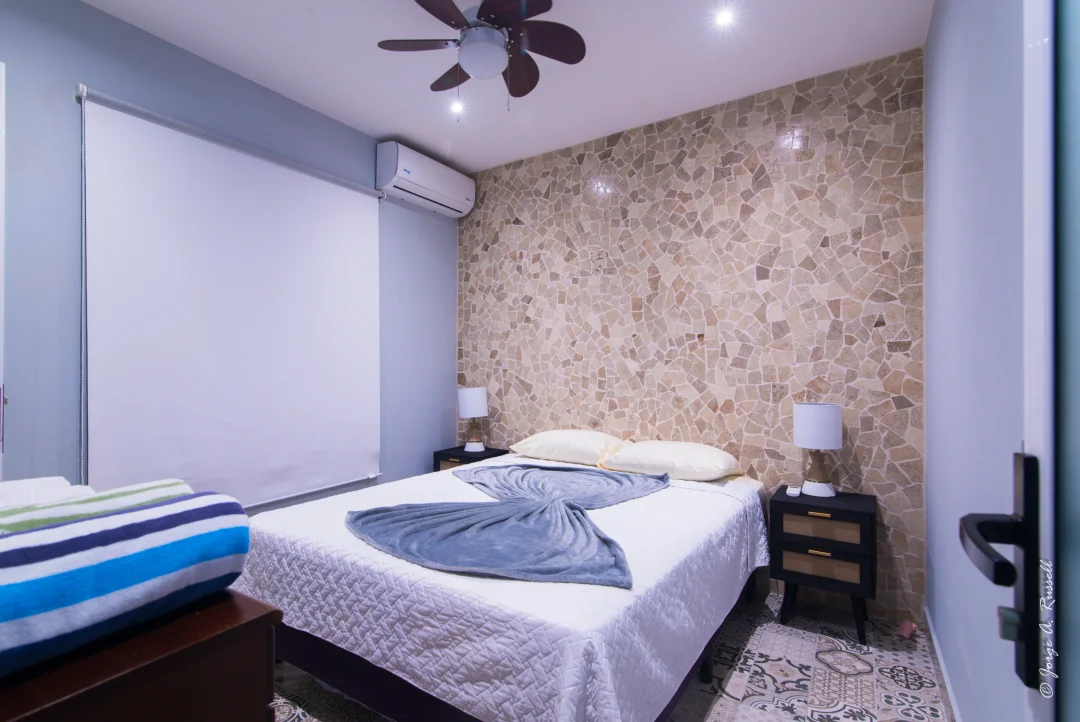 Corals Palma · bedroom with stone accent wall